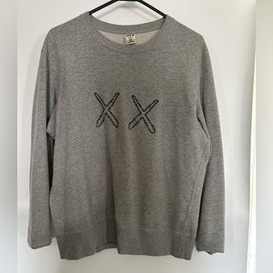 Small grey men’s Uniqlo x Kaws x Sesame Street sweater.